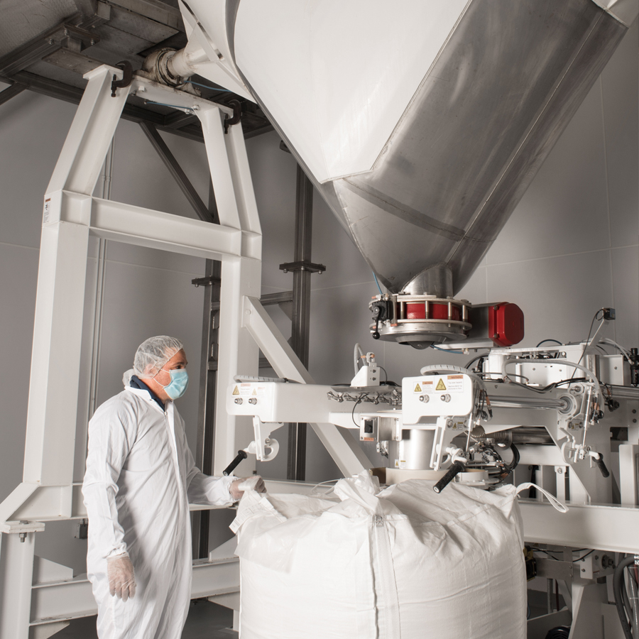 Powder blender, Powder Ingredients Blender, Worker in protective gear operating a large power blender for BCAA supplements.